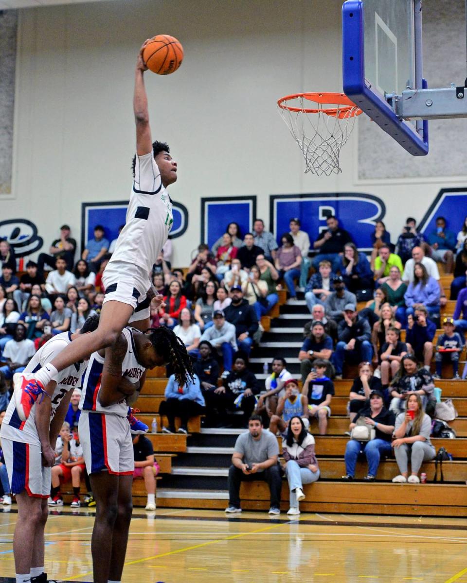 St. Marys Cayden Ward jumps over Modesto Christians Drevon Johnson and Armon Naweed during the Slam Dunk Contest during the 27th Annual Six County All Star Senior Basketball Classic Boys game at Modesto Junior College in Modesto California on April 27, 2024. Ward won the Slam Dunk Contest.