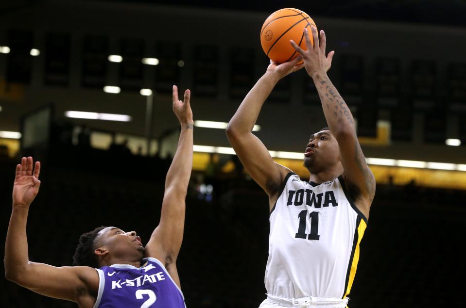 Iowa’s Tony Perkins (11) shoots as Kansas State’s Tylor Perry (2) in a first-round NIT game Tuesday, March 19, 2024 at Carver-Hawkeye Arena in Iowa City, Iowa.