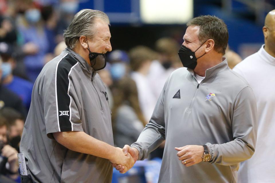 Kansas coach Bill Self shakes hands with West Virginia coach Bob Huggins before the start of Saturday's game inside Allen Fieldhouse.