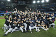 The New York Yankees pose for team photographs after defeating the Toronto Blue Jays to clinch the AL East, in Toronto on Tuesday, Sept. 27, 2022. (Nathan Denette/The Canadian Press via AP)