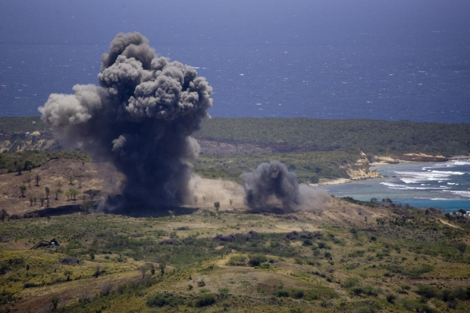 FILE - In this April 17, 2008 file photo, an unexploded ordinance is blown up in a controlled demolition at the former Vieques Naval Training Range, on Vieques island, Puerto Rico. An extensive cleanup of Vieques is underway and the Navy says it's close to finishing work on a former munitions disposal site on the island. It would be a milestone for the cleanup but the plan has sparked criticism. (AP Photo/Brennan Linsley, File)