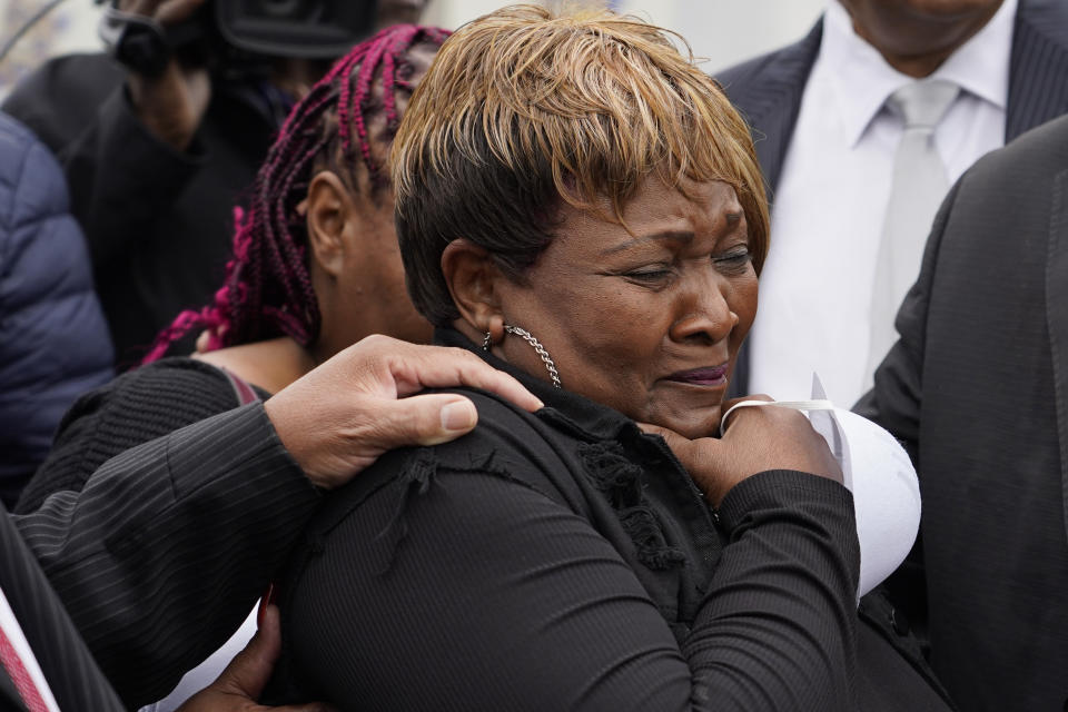 Bettersten Wade, mother of Dexter Wade, a 37-year-old man who died after being hit by a Jackson, Miss., police SUV driven by an off-duty officer, cries while watching her son's body transferred to a mortuary transport, after being exhumed from a pauper's cemetery near the Hinds County Penal Farm in Raymond, Monday, Nov. 13, 2023. Civil rights attorney Ben Crump said Monday he is asking for a federal investigation as to why authorities waited several months to notify the family of Wade's death. (AP Photo/Rogelio V. Solis)