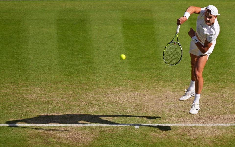 Holger Rune serves