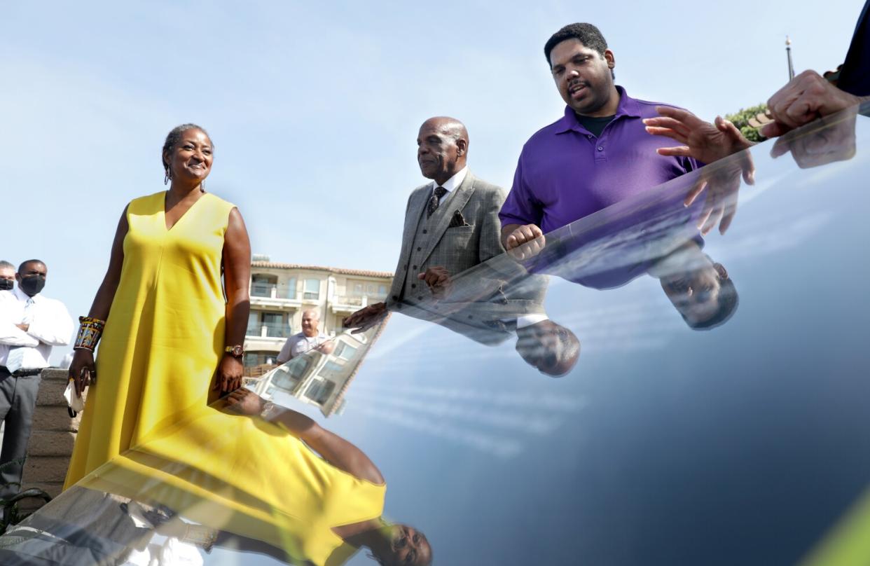 Los Angeles County Supervisor Holly Mitchell, State Sen. Steven Bradford, and Anthony Bruce stand beside a life-size mockup