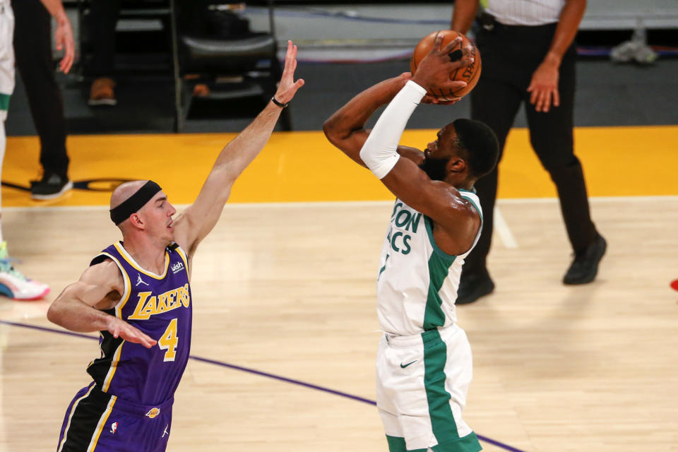 Boston Celtics' Jaylen Brown shoots over Los Angeles Lakers' Alex Caruso (4) during the first half of an NBA basketball game, Thursday, April 15, 2021, in Los Angeles. (AP Photo/Ringo H.W. Chiu)