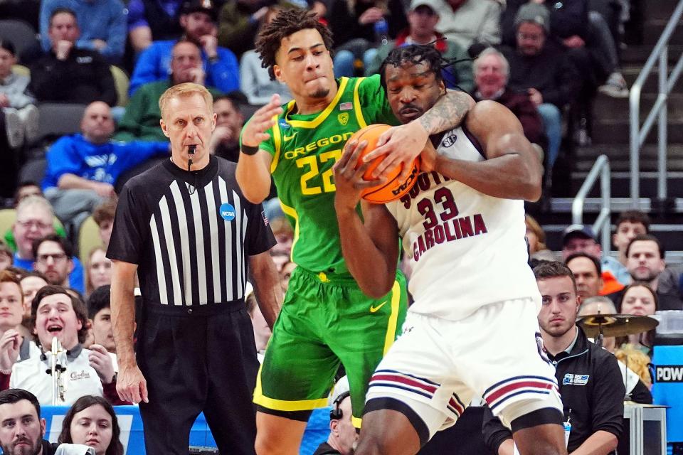 Oregon Ducks guard Jadrian Tracey (22) and South Carolina Gamecocks forward Josh Gray (33) go for a rebound during the first half in the first round of the 2024 NCAA Tournament at PPG Paints Arena in Pittsburgh on Thursday.