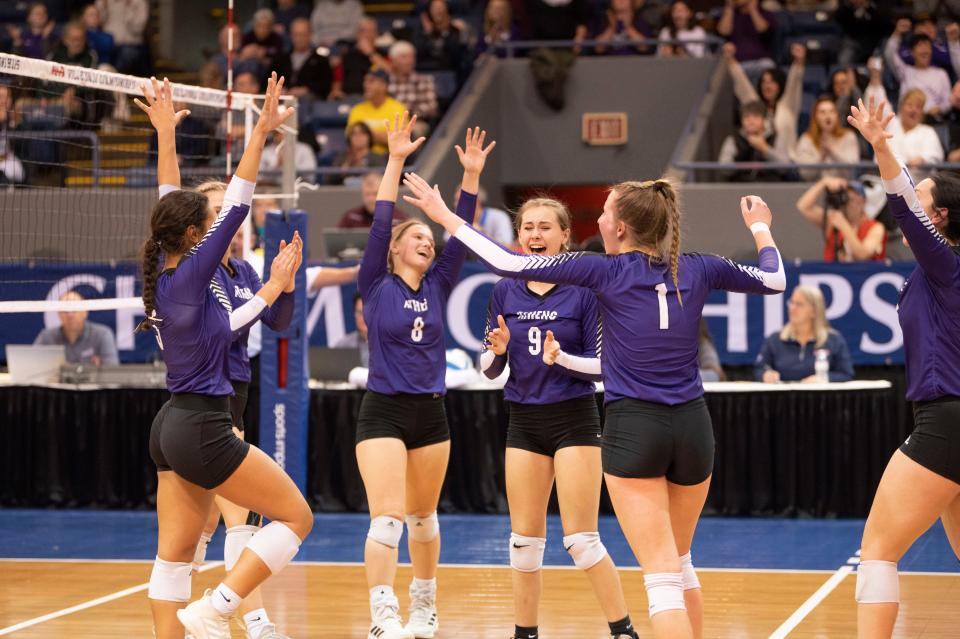 Athens players celebrate a set win during the MHSAA Semifinal match at Kellogg Arena on Thursday, Nov. 17, 2022.
