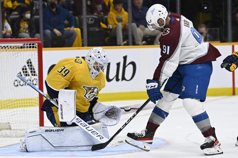 Nashville Predators goaltender Connor Ingram (39) stops a shot as Colorado Avalanche center Nazem Kadri (91) looks for the rebound during the first period in Game 3 of an NHL hockey Stanley Cup first-round playoff series Saturday, May 7, 2022, in Nashville, Tenn. (AP Photo/Mark Zaleski)