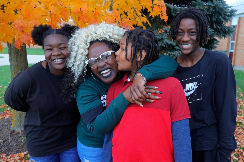 Anita Cobb, 35, with her three kids (L to R) Amaria Cobb, 13, DJ Davis, 13, and Isaiah Cobb, 14 at St. Johns High School in St. Johns, Michigan on Friday, Nov. 5, 2021.
Cobb works two jobs and the child tax credit comes in handy with various family expenses.