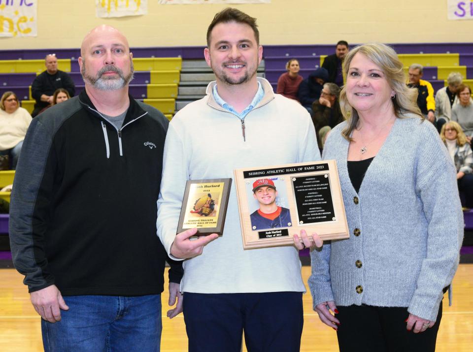 Josh Hurford chose his parents, Kevin and Leigh (Carpenter) Hurford, as his presenters Friday, Dec. 29, 2023, for the induction ceremony for the Sebring Athletic Hall of Fame ceremony prior to Sebring McKinley's game against Reimer Road Christian at McKinley Jr./Sr. High School.