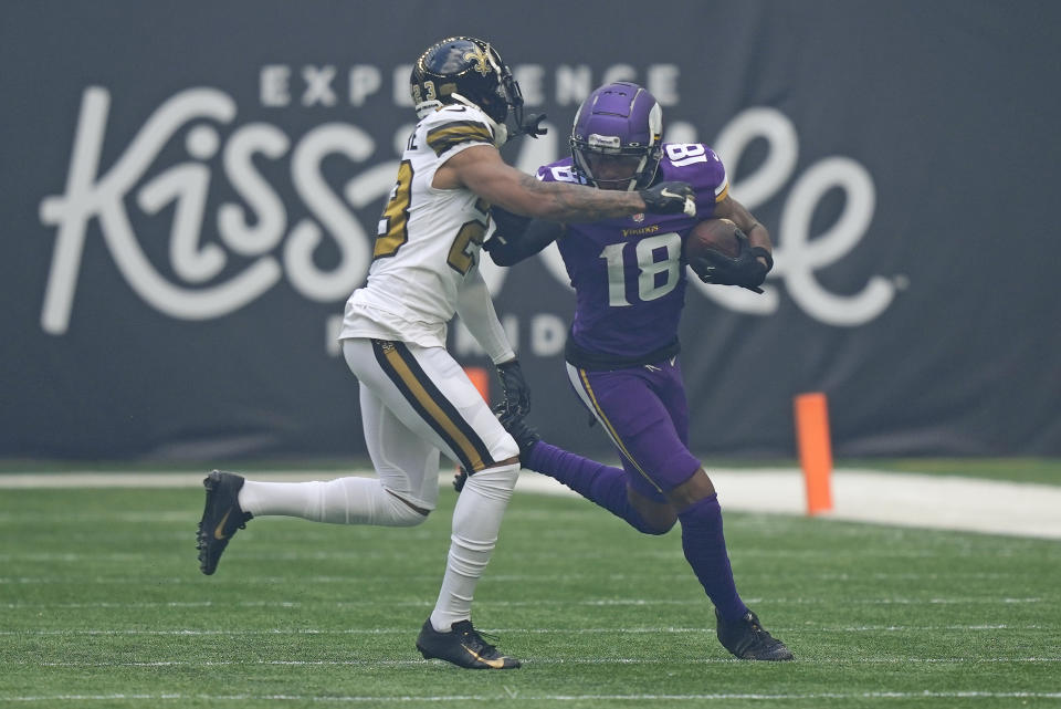 Minnesota Vikings wide receiver Justin Jefferson (18) is tackled by New Orleans Saints cornerback Marshon Lattimore (23) during an NFL match between Minnesota Vikings and New Orleans Saints at the Tottenham Hotspur stadium in London, Sunday, Oct. 2, 2022. (AP Photo/Frank Augstein)