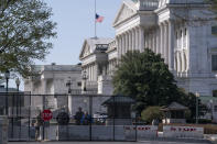 U.S. Capitol Police officers and members of the National Guard keep watch at the Constitution Avenue entrance to the East Plaza of the Capitol where an officer was killed Friday as a man rammed a car into the barricade, in Washington, Monday, April 5, 2021. Security concerns over the events of the past four months may alter not only how the U.S. Capitol Police operate, but also whether the historically public grounds can remain open. (AP Photo/J. Scott Applewhite)