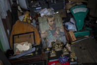 A painting of the last Russian Czar, Nicholas II, is surrounded by old items at a flea market stall in Kharkiv, Ukraine, Sunday, May 22, 2022. (AP Photo/Bernat Armangue)