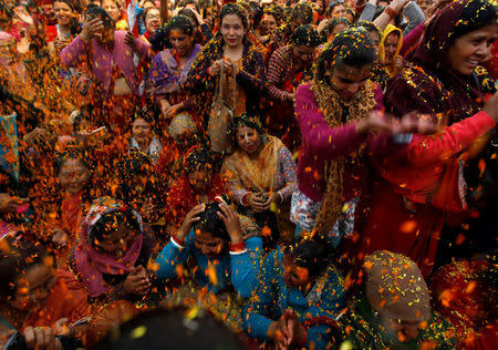 Devotees sing and dance as flower petals and colour are thrown while celebrating puspa holi to mark the Gaura Purnima festival in Kathmandu, Nepal March 21, 2019. The festival is celebrated to mark the day when Lord Krishna changed his colour to golden and advent as Gauranga. REUTERS/Navesh Chitrakar