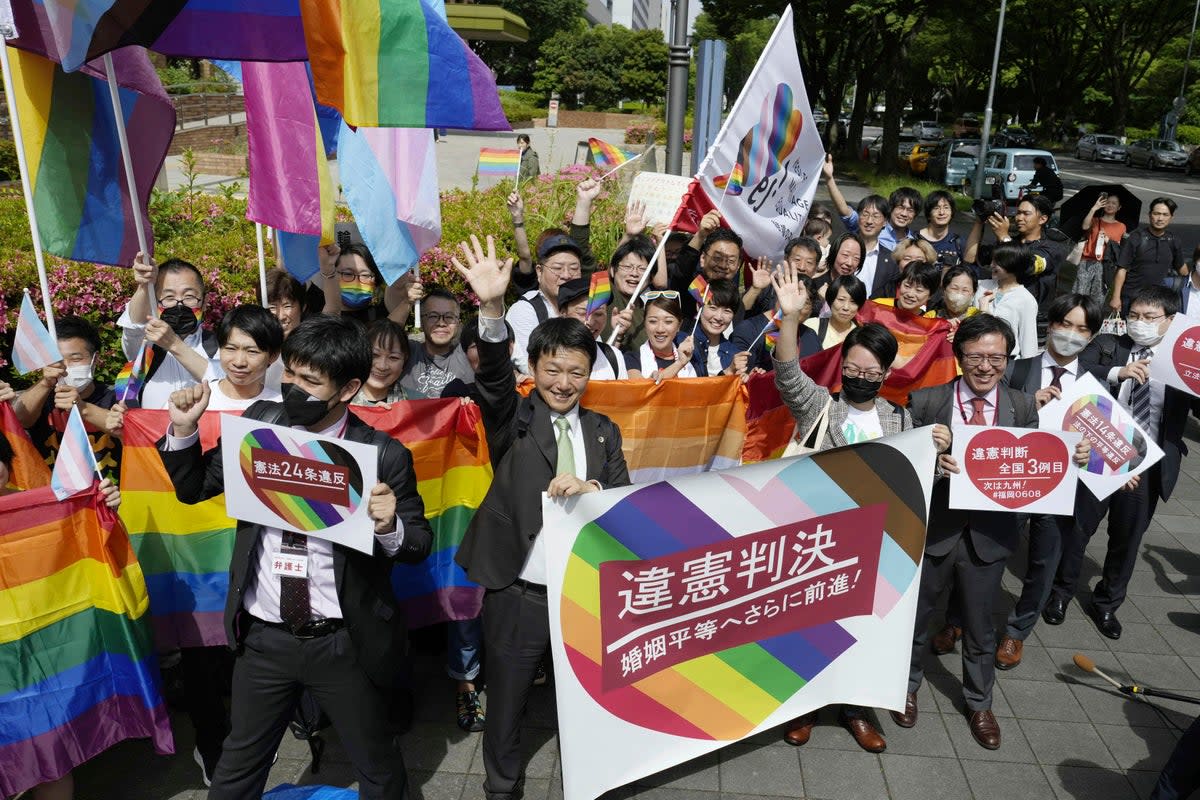 Celebrations outside Nagoya District Court in Japan on Tuesday after the ruling that the bar on same-sex marriage is unconstitutional (AP)