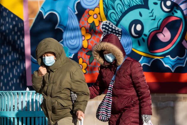 Pedestrians walk along West Argyle Street in the Uptown neighborhood of Chicago on Saturday. Temperatures climbed up to 14 degrees Saturday afternoon, after Chicago was below zero for 29 hours, according to the National Weather Service.