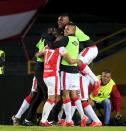 Players of Colombia's Santa Fe celebrate after their teammate Yamilson Rivera scored a goal against Argentina's Estudiantes de La Plata during their Copa Libertadores soccer match in Bogota, Colombia May 12, 2015. REUTERS/Jose Miguel Gomez