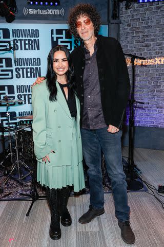 <p>Mike Coppola/Getty</p> Demi Lovato and Howard Stern pose together on set at 'The Howard Stern Show' on Sept. 11, 2023