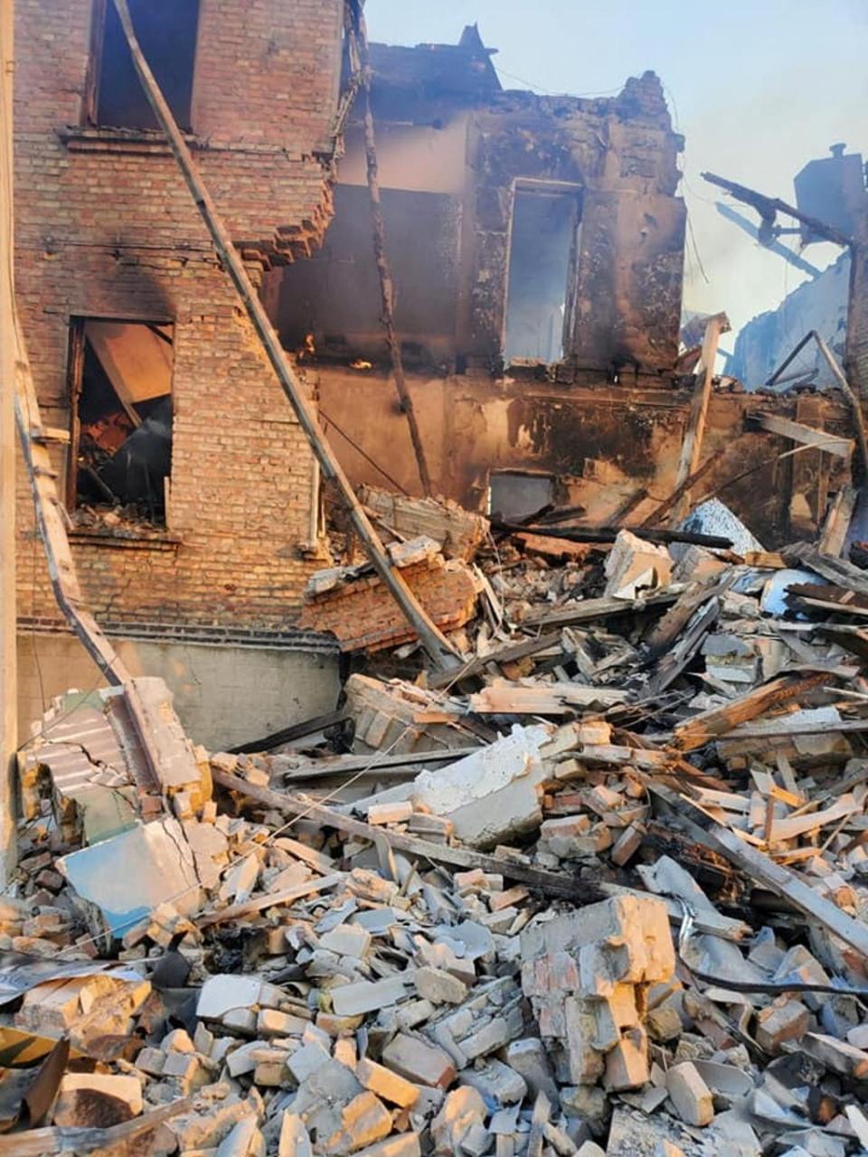 Debris next to a partially collapsed building is seen after a school building was hit (via REUTERS)