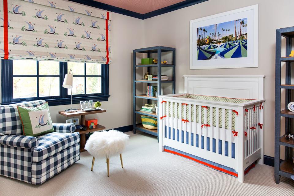 <p>Soft, cozy materials? Check. Timeless furniture? Check. Bows? Check. This nursery designed by <a href="http://maalleninteriors.com/" rel="nofollow noopener" target="_blank" data-ylk="slk:MA Allen;elm:context_link;itc:0;sec:content-canvas" class="link ">MA Allen</a> strikes the perfect balance between child-friendly and bold. The bright red and deep blue accents spice up the cream foundation. We're loving unexpected the pops of green, too. Instead of super-sweet, baby-specific artwork, opt for playful but versatile photography, like this California snapshot. </p>