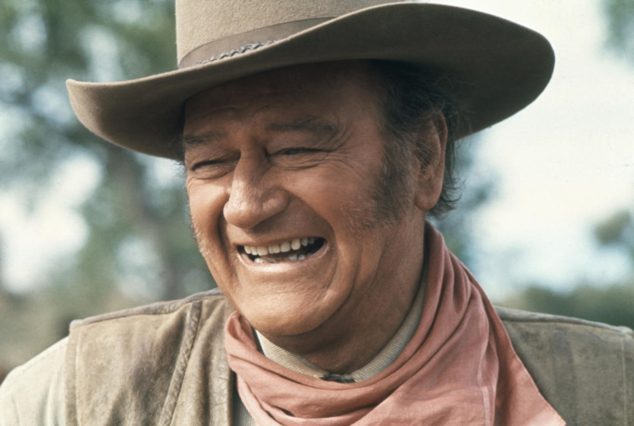 John Wayne laughing in scene from the western 'The Undefeated', 1969. (Photo by Screen Archives/Getty Images).