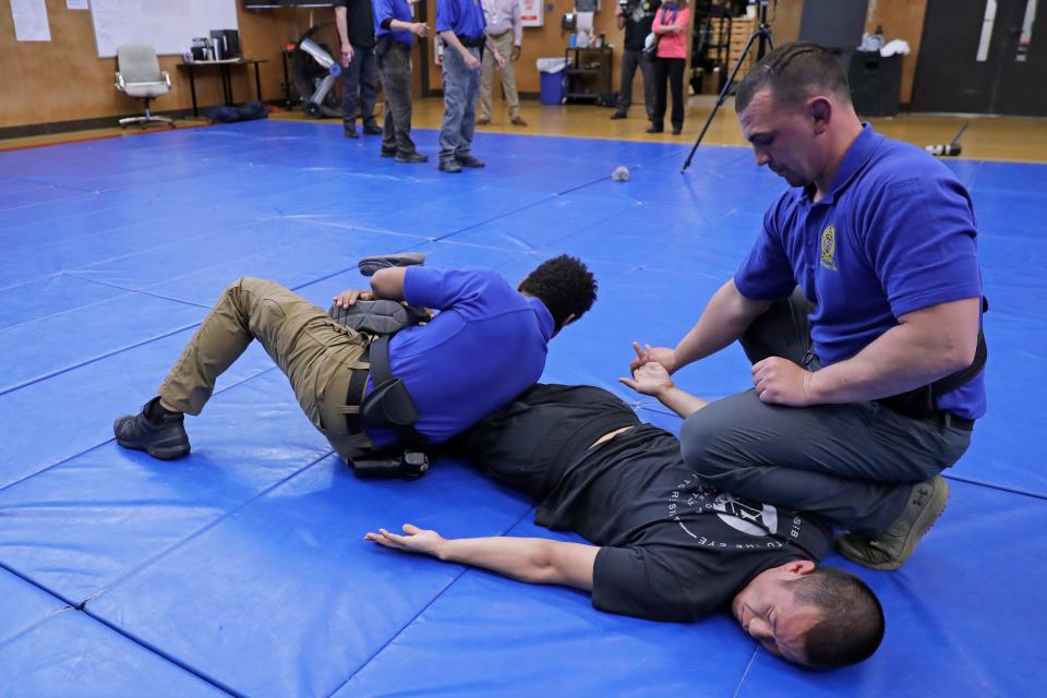 Demonstrating takedown and restraint techniques at a police training facility in Burien, Wash., in 2020.