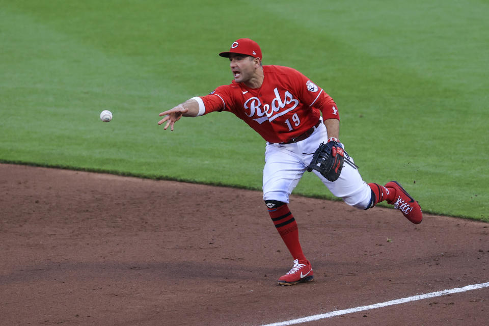 Cincinnati Reds' Joey Votto fields the ball and throws out Arizona Diamondbacks' Nick Heath at first base during the third inning of a baseball game in Cincinnati, Wednesday, April 21, 2021. (AP Photo/Aaron Doster)