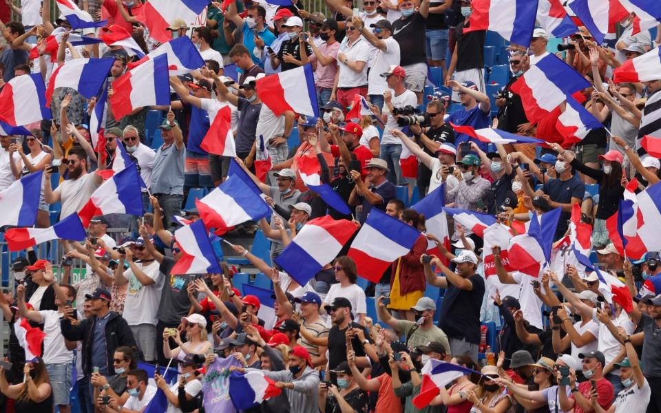 Formula One F1 - French Grand Prix - Circuit Paul Ricard, Le Castellet, France - June 20, 2021 General view of fans in the stands waving flags of France before the race - REUTERS/Eric Gaillard