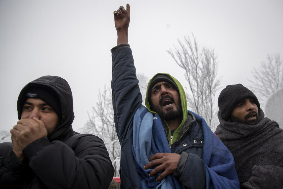 Migrants chant as they gather in protest of conditions at the Vucjak refugee camp outside Bihac, northwestern Bosnia, Tuesday, Dec. 3, 2019. Despite calls for their relocation before winter, hundreds of migrants remain stuck in a make-shift tent camp in northwestern Bosnia as a spate of snowy and cold weather hit the region. (AP Photo/Darko Bandic)