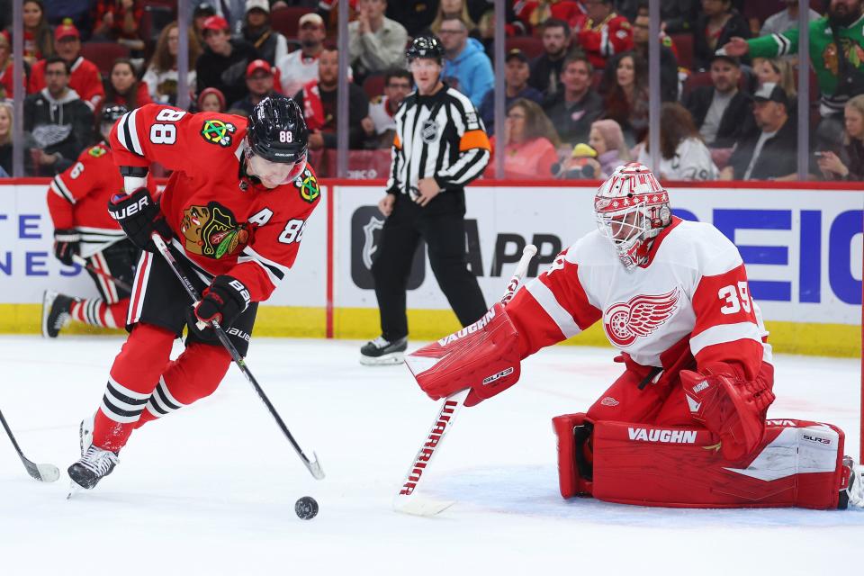 Patrick Kane of the Chicago Blackhawks shot is defended by Alex Nedeljkovic of the Detroit Red Wings during the second period at United Center in Chicago on Friday, Oct. 21, 2022.Getty Images)