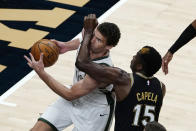 Milwaukee Bucks center Brook Lopez drives against Atlanta Hawks center Clint Capela (15) during the first half of an NBA basketball game Thursday, April 15, 2021, in Atlanta. (AP Photo/John Bazemore)