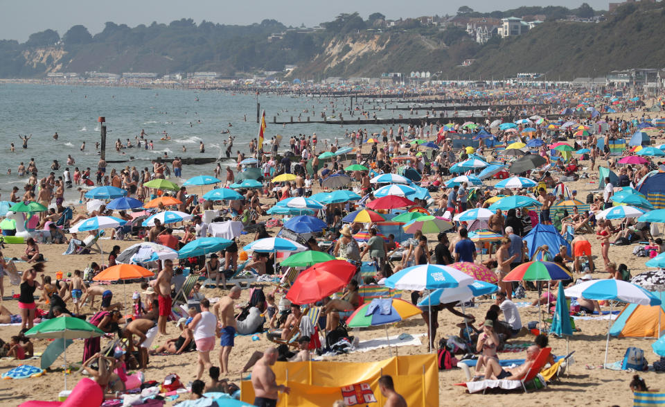 People enjoy the warm weather on Bournemouth beach in Dorset (Picture: PA)