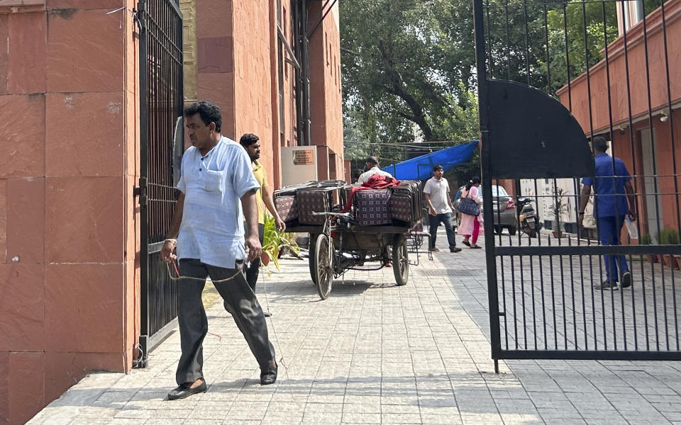 Workers take down tents and carry back hired chairs on a handcart after the people's summit on G20 was ended, in New Delhi, India, Sunday, Aug.20, 2023. Indian police intervened to stop a meeting of prominent activists, academics and politicians discussing issues ahead of a summit of the Group of 20 industrialized and developing nations next month that will be hosted in New Delhi, citing law and order issues, the meeting's organizers said on Sunday. (AP Photo/Piyush Nagpal)