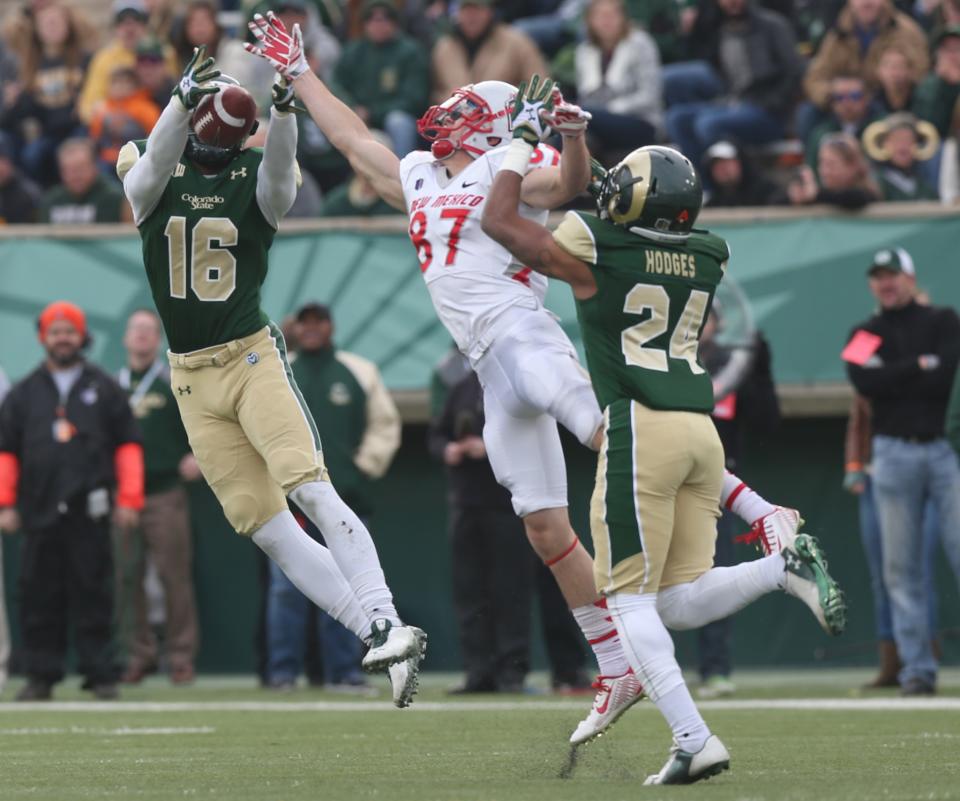 Colorado State safety Trent Matthews, left, tries to intercept pass intended for New Mexico wide receiver Jeric Magnant as Colorado State defensive back Preston Hodges defends in the third quarter of Colorado State's 58-20 victory in an NCAA college football game in Fort Collins, Colo., on Saturday, Nov. 22, 2014. (AP Photo/David Zalubowski)