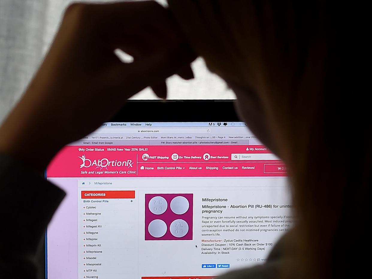 In this photo illustration, a person looks at an Abortion Pill (RU-486) for unintended pregnancy from Mifepristone displayed on a computer on May 8, 2020, in Arlington, Virginia. - One week after Sally realized she was pregnant, her home state Texas temporarily banned abortions, deeming them unnecessary elective procedures that were suspended because of the coronavirus crisis.So, the 34-year-old, whose name has been changed for this story to protect her privacy, took matters into her own hands -- something she never would have considered in the past. Having split with her boyfriend, she decided to buy pills on the internet, and perform her own abortion at home. (Photo by Olivier DOULIERY / AFP) (Photo by OLIVIER DOULIERY/AFP via Getty Images)