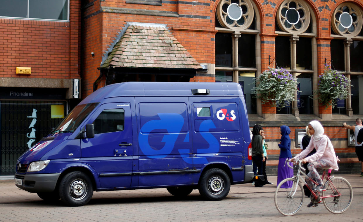 A G4S security van is parked outside a bank in Loughborough, central England, August 28, 2013. REUTERS/Darren Staples/File Photo
