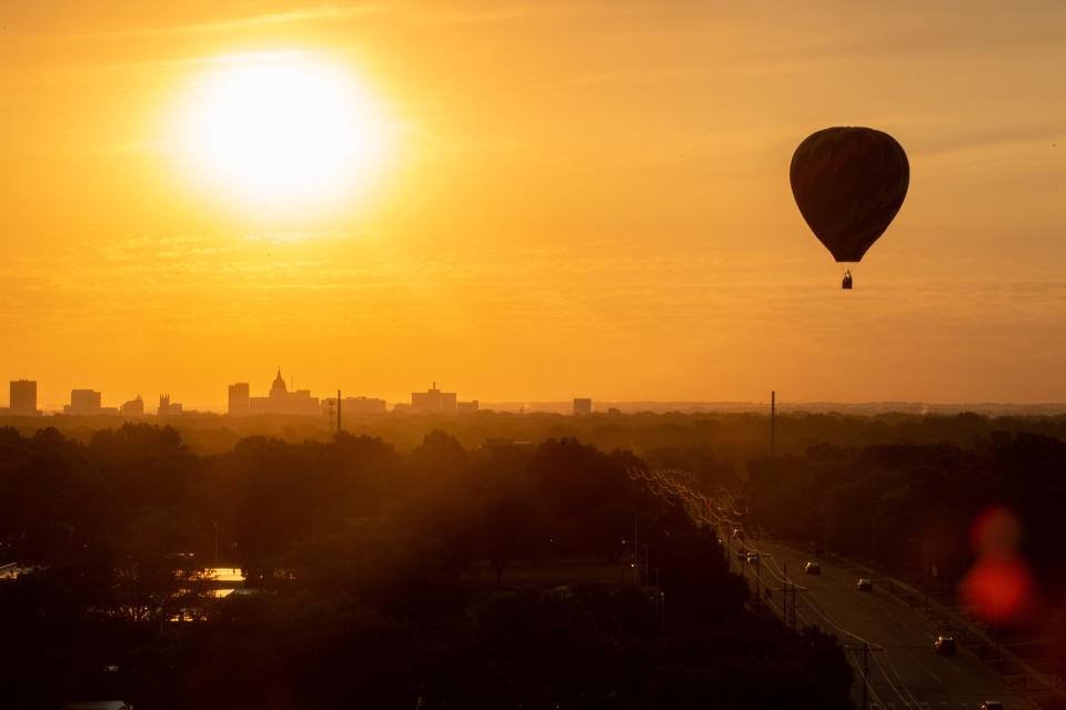 Lori Hutchinson's balloon, "Breaking Dawn," rises above S.W. Huntoon Street and downtown Topeka during a media flight held to promote last year's Huff-n-Puff balloon rally.  This photo placed second in the annual Kansas Press Association journalism contest's Division VII's general news category after being taken by Evert Nelson, chief photojournalist/creative director for The Capital-Journal.