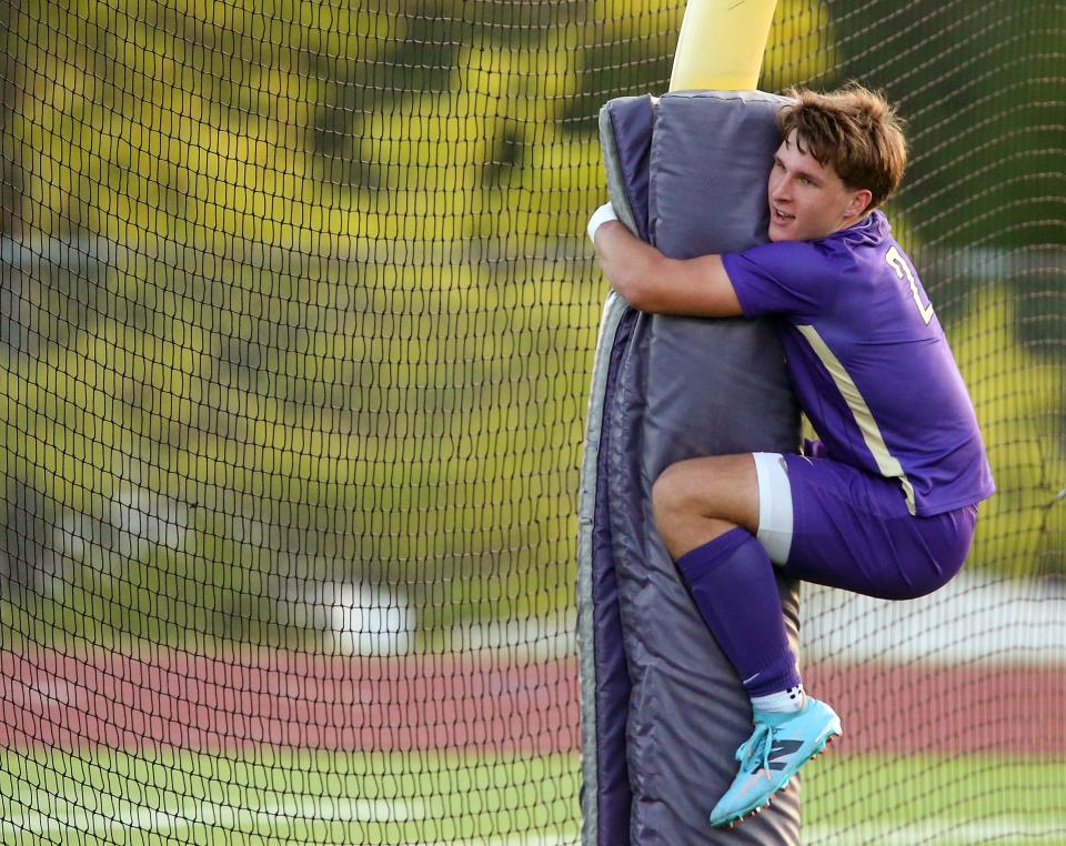 North Kitsap’s Mason Chmielewski jumps up and embraces the goal post in celebration after one of his goals against WF West in the their a 6-0 win for the 2A State Soccer opening round at North Kitsap High School on Tuesday, May 14, 2024.