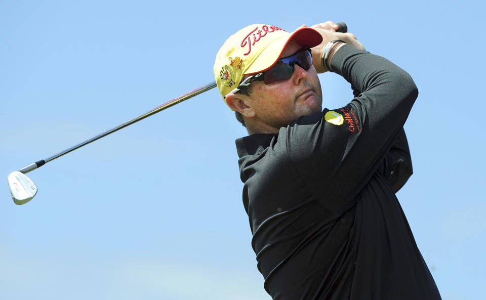 FILE - In this Nov. 17, 2013 file photo, Jarrod Lyle of Australia tees off during the final round of the Australian Masters golf tournament at Royal Melbourne Golf Club in Melbourne. Lyle has died after a long struggle with cancer. He was 36. "It breaks my heart to tell everyone that Jarrod is no longer with us," the golfer's wife, Briony Lyle, said in a statement Thursday, Aug. 9, 2018. (AP Photo/Andy Brownbill, File)