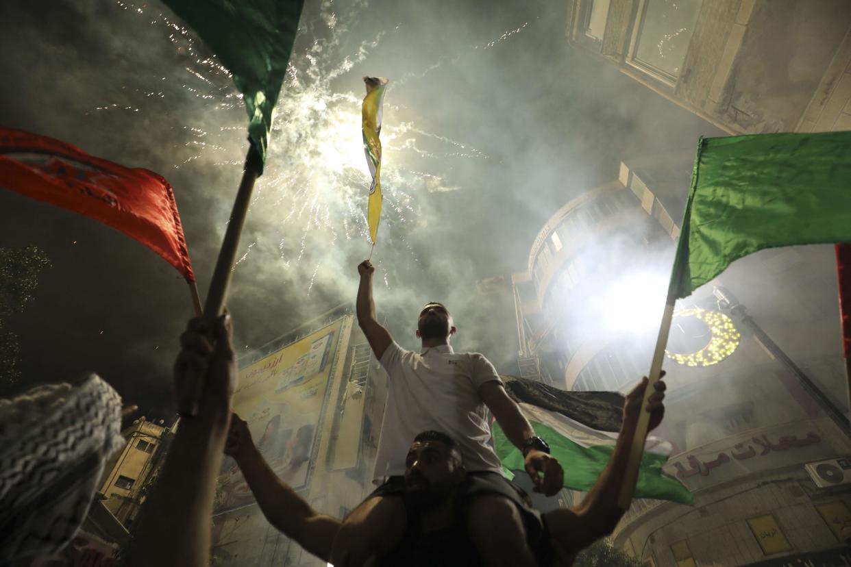 <p>Palestinians celebrate in Ramallah in support of the resistance in Gaza, after the ceasefire was announced</p> (AFP via Getty Images)