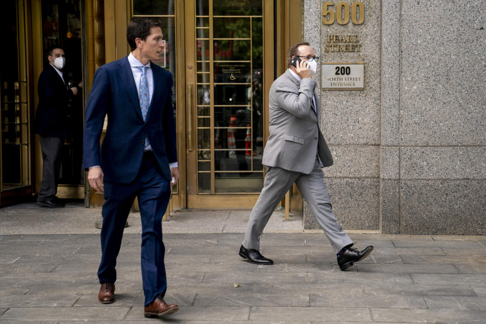 Kevin Spacey, right, leaves court after testifying in a civil lawsuit, Thursday, May 26, 2022, in New York. British prosecutors have charged Spacey with four counts of sexual assault against three men. The 62-year-old double Academy Award winner was questioned by British police in 2019 about claims by several men that he had assaulted them. The U.K. charges were announced Thursday, as Spacey was testifying in a courtroom in New York City in a civil lawsuit. (AP Photo/John Minchillo)