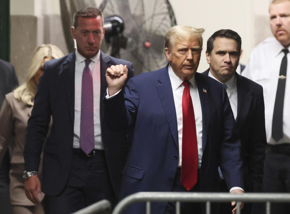 Republican presidential candidate and former U.S. President Donald Trump gestures while he walks, as his criminal trial over charges that he allegedly falsified business records to conceal money paid to silence porn star Stormy Daniels in 2016 continues, at Manhattan state court in New York, Tuesday, April 23, 2024. (Brendan McDermid/Pool Photo via AP)