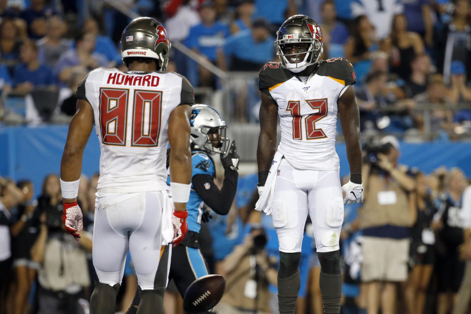 Tampa Bay Buccaneers tight end O.J. Howard (80) and wide receiver Chris Godwin (12) celebrate Godwin's touchdown against the Carolina Panthers during the first half of an NFL football game in Charlotte, N.C., Thursday, Sept. 12, 2019. (AP Photo/Brian Blanco)