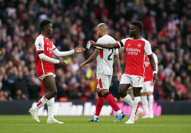 Eddie Nketiah is handed the captain's armband by Bukayo Saka 