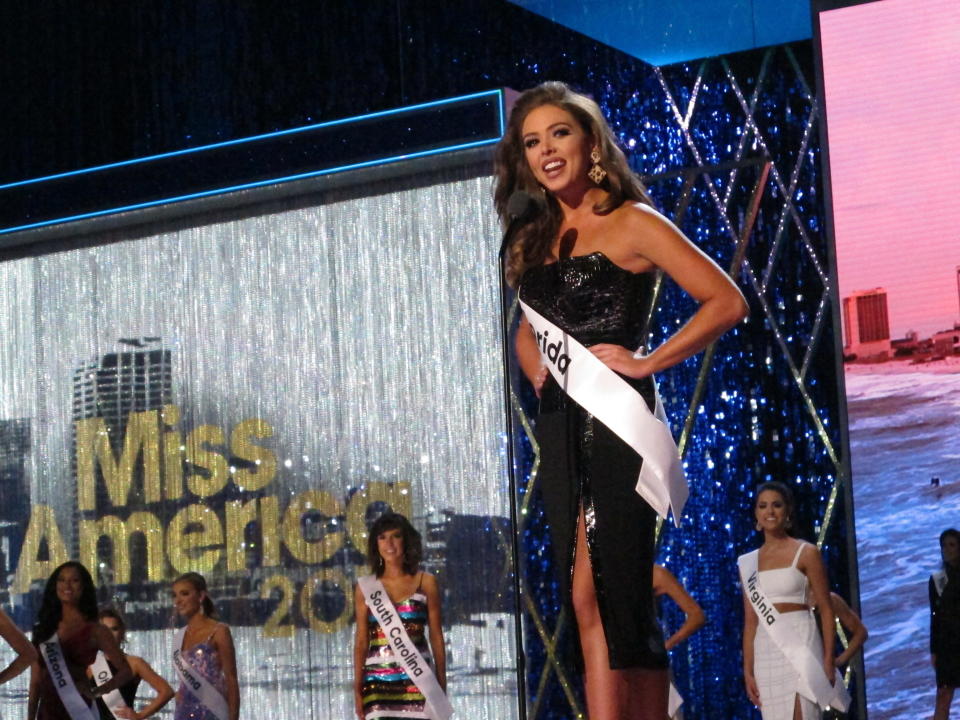 Miss Florida Taylor Tyson introduces herself at the start of the third and final night of preliminary competition at the Miss America competition in Atlantic City N.J. on Friday Sept. 7, 2018. (AP Photo/Wayne Parry)