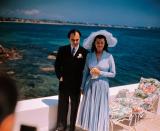 <p>After her marriage to director Orson Welles ended, '40s film star Rita Hayworth caught the attention of Prince Aly Khan. The two married in 1949 on the French Rivera in a highly publicized ceremony. Rita chose a light blue, pleated dress and matching wide brimmed hat for the occasion — a style that was soon replicated by many across the United States. </p>