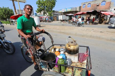 A man rides a tricycle he uses for selling coffee on a street in Hodeidah, Yemen December 15, 2018. REUTERS/Abduljabbar Zeyad