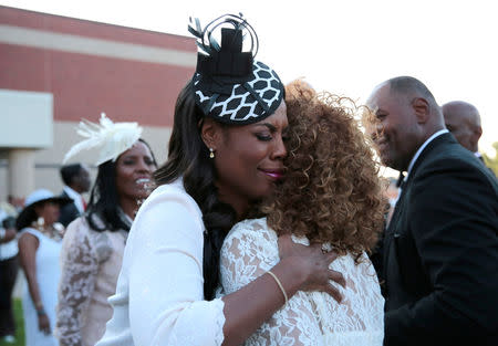 Former White House aide and reality television participant Omarosa Manigault Newman hugs a woman following the funeral service for the late singer Aretha Franklin at the Greater Grace Temple in Detroit, Michigan U.S. August 31, 2018. REUTERS/Rebecca Cook