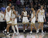 Providence players Ed Croswell, left, Jared Bynum (4), Al Durham (1), Alyn Breed, second right, and Noah Horchler (14) celebrate as they extend their lead late during the second half of an NCAA college basketball game against Butler, Sunday, Jan. 23, 2022, in Providence, R.I. (AP Photo/Mary Schwalm)