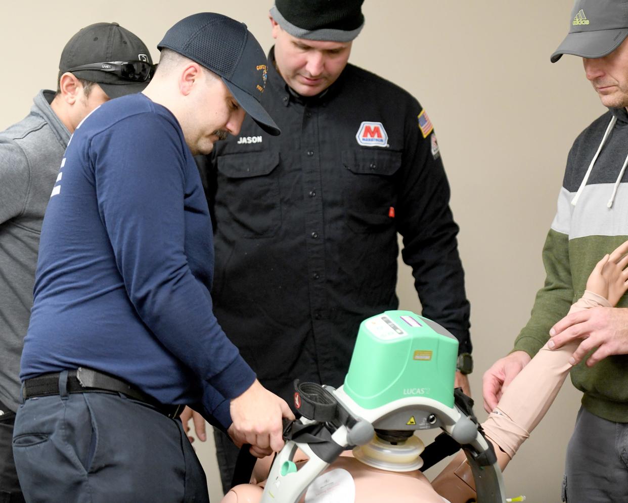 Canton Township firefighter/EMT Kris Moll, left, works on mutual training with the private Marathon Fire Department at the Canton Township Community Center.